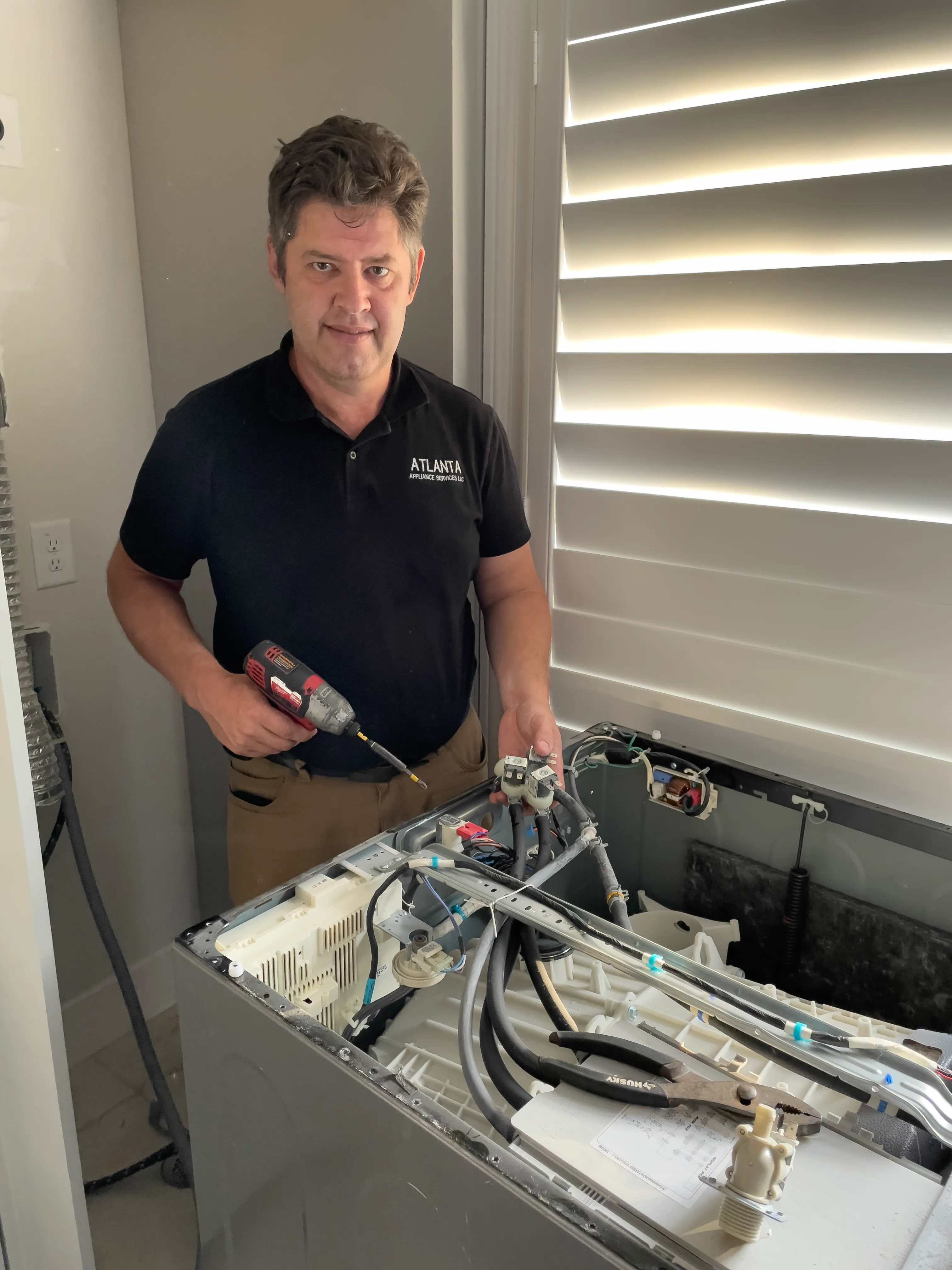 Stan the technician repairing a washer